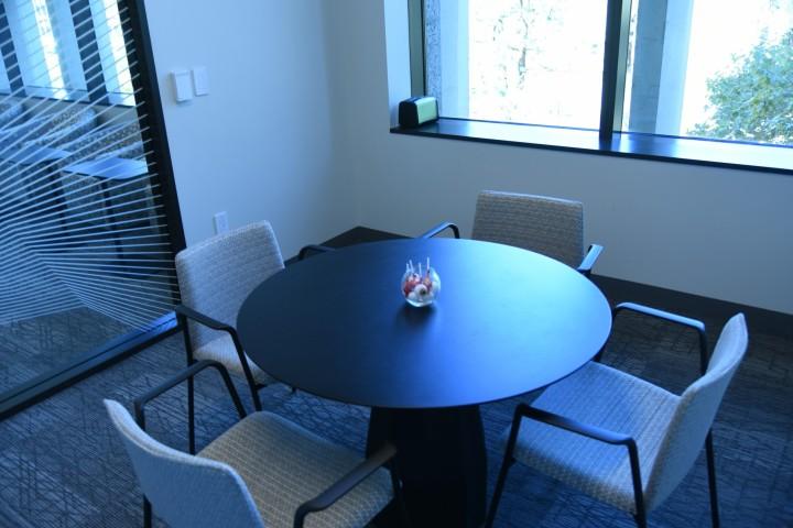 Room with a window and a small round table with four chairs.